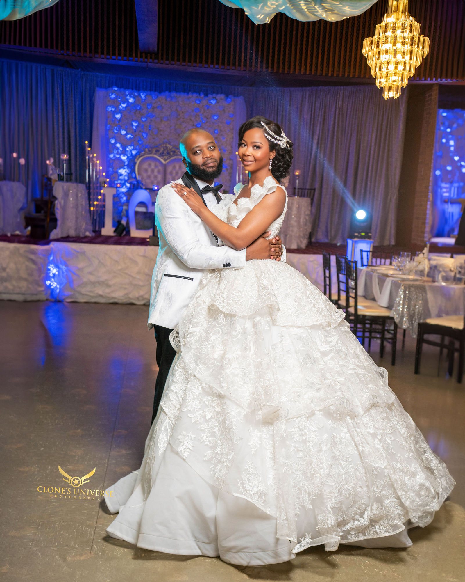Couple’s first dance beneath a crystal chandelier