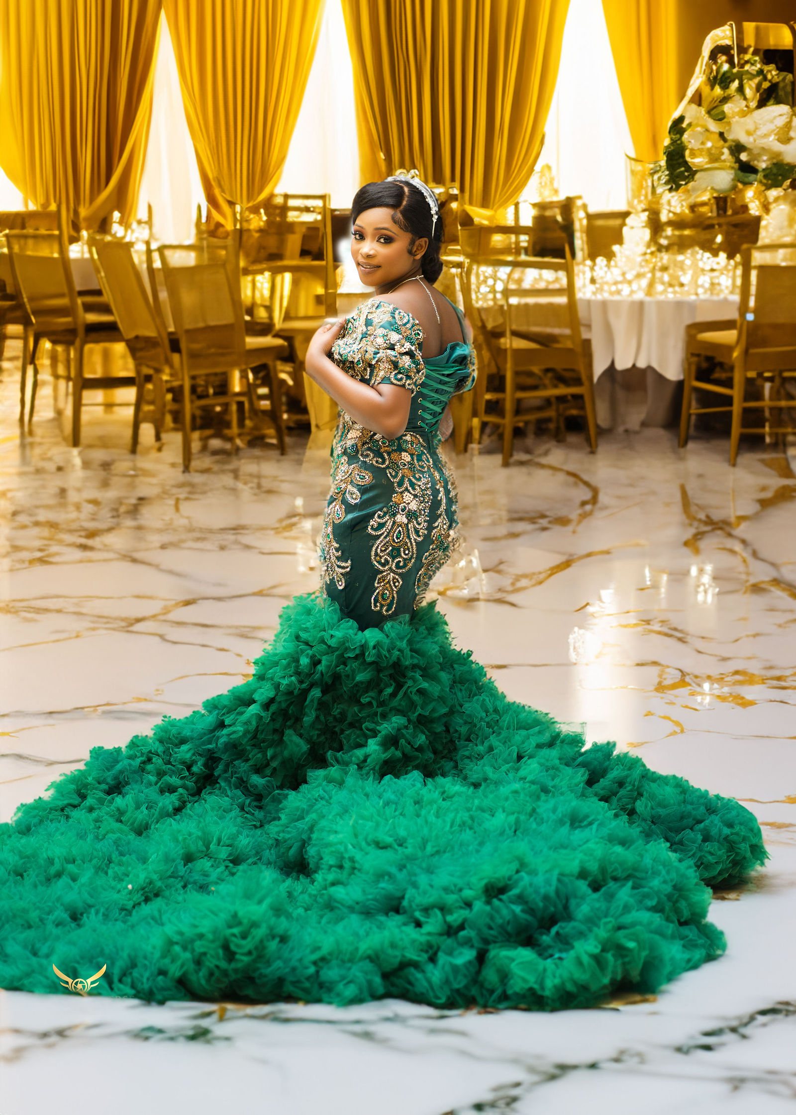 Bride in an emerald gown in a gold ballroom