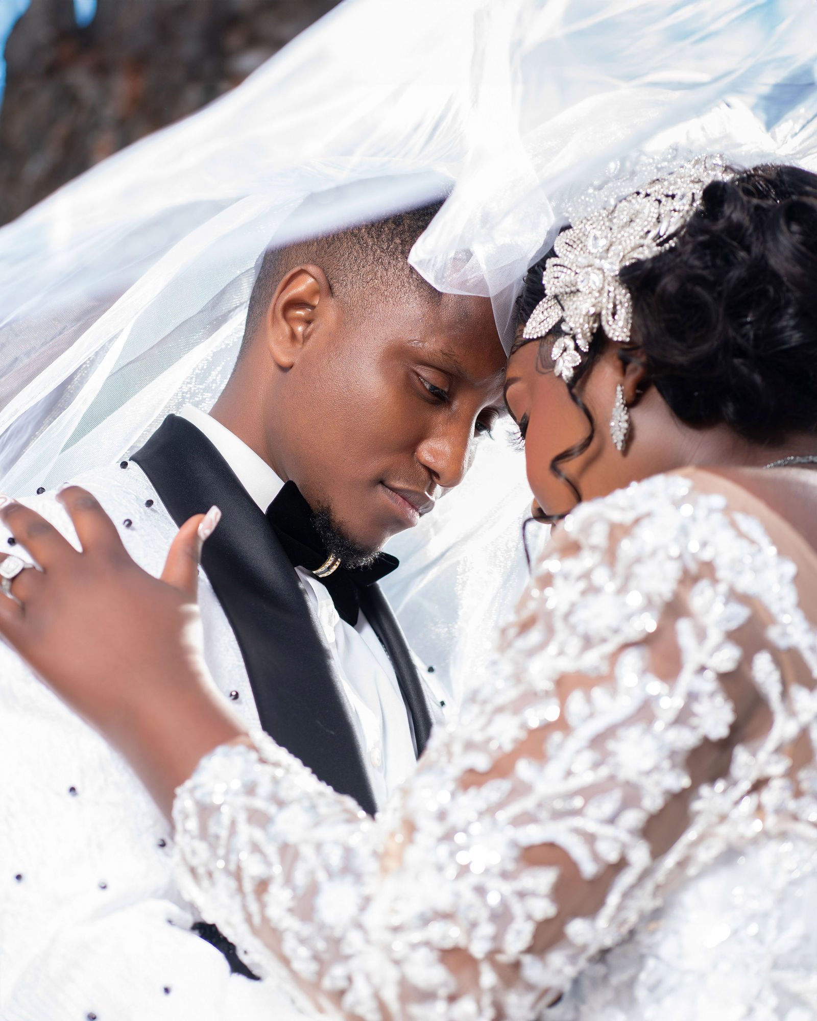 Bride and groom framed by lace and veil