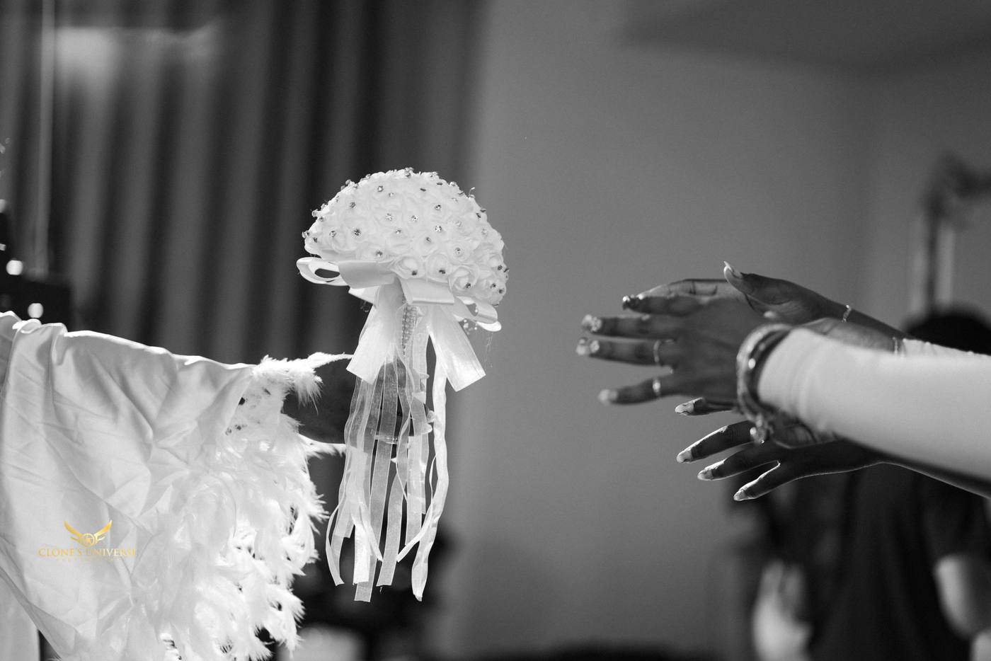 Black and white bouquet toss with hands reaching