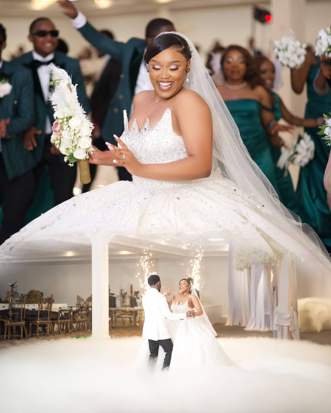 Bride dancing in a beaded ball gown, with the couple’s first dance in fog below
