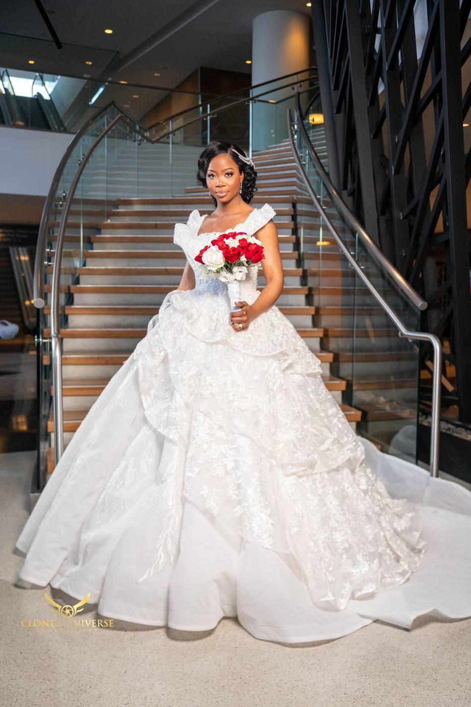 Bride in a lace ball gown on a curved staircase